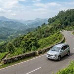 Scenic winding road trip through lush green hills and tea plantations in Kerala India
